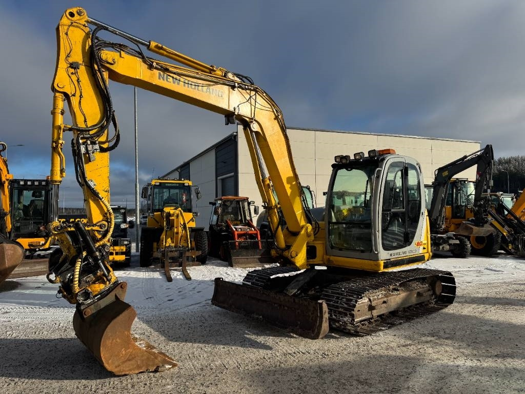 New Holland MYYTY! SOLD! E80MSR PYÖRITTÄJÄLLÄ - Mini bager: slika 2 New Holland MYYTY! SOLD! E80MSR PYÖRITTÄJÄLLÄ - Mini bager: slika 2