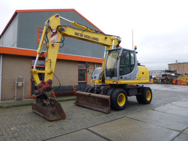 NEW HOLLAND MH PLUS - Bager na kolesih: slika 1 NEW HOLLAND MH PLUS - Bager na kolesih: slika 1