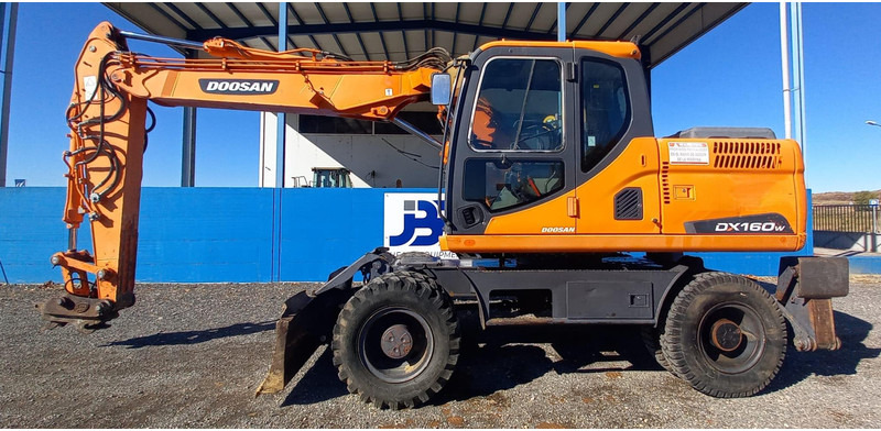 Doosan DX140W-3 - Bager na kolesih: slika 1 Doosan DX140W-3 - Bager na kolesih: slika 1