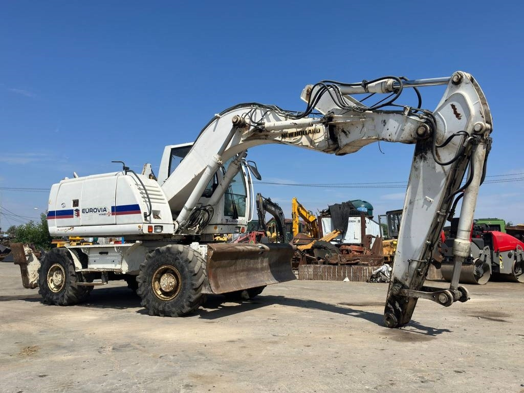 New Holland MH Plus - Bager na kolesih: slika 1 New Holland MH Plus - Bager na kolesih: slika 1