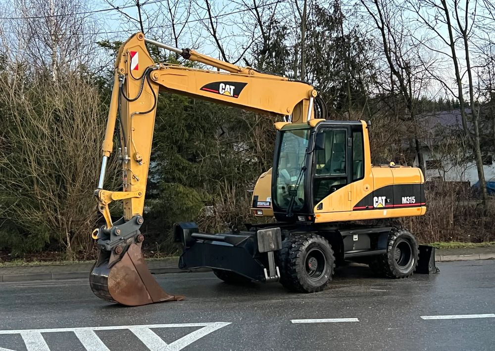 Caterpillar CAT M315C CATERPILLAR SPROWADZONY Bardzo Dobry Stan - Bager na kolesih: slika 1 Caterpillar CAT M315C CATERPILLAR SPROWADZONY Bardzo Dobry Stan - Bager na kolesih: slika 1